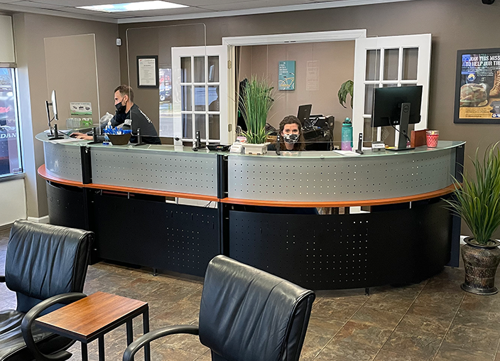 image of front desk inside ABS Unlimited with 2 employees behind the desk