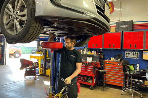 A technician from ABS Unlimited Auto Repair is performing an oil change | Fairfax VA
