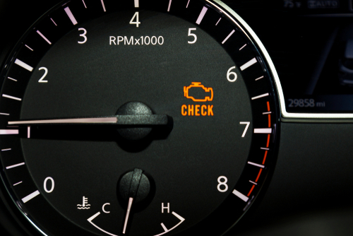 Top reasons your check engine light is on in Fairfax, Va with ABS Unlimited Auto Repair. Close up image of illuminated check engine light on car dashboard.